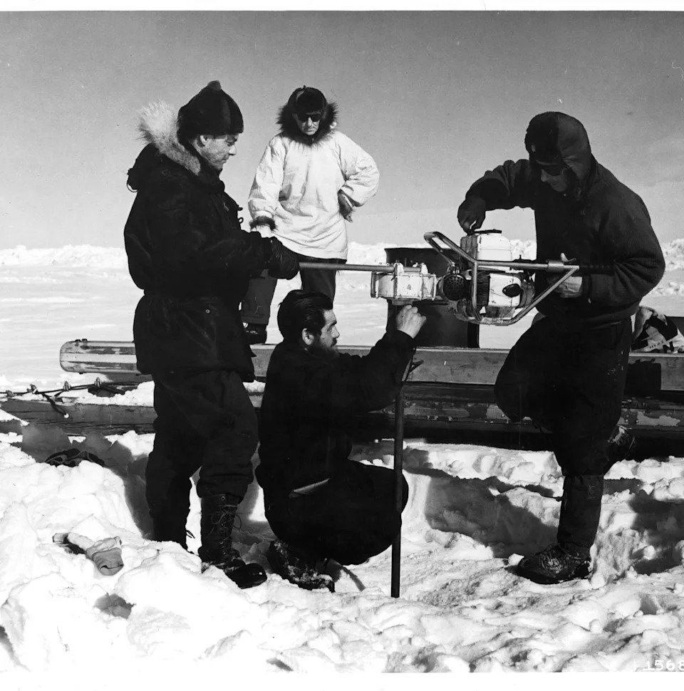 Scientists drilling into an ice sheet.
