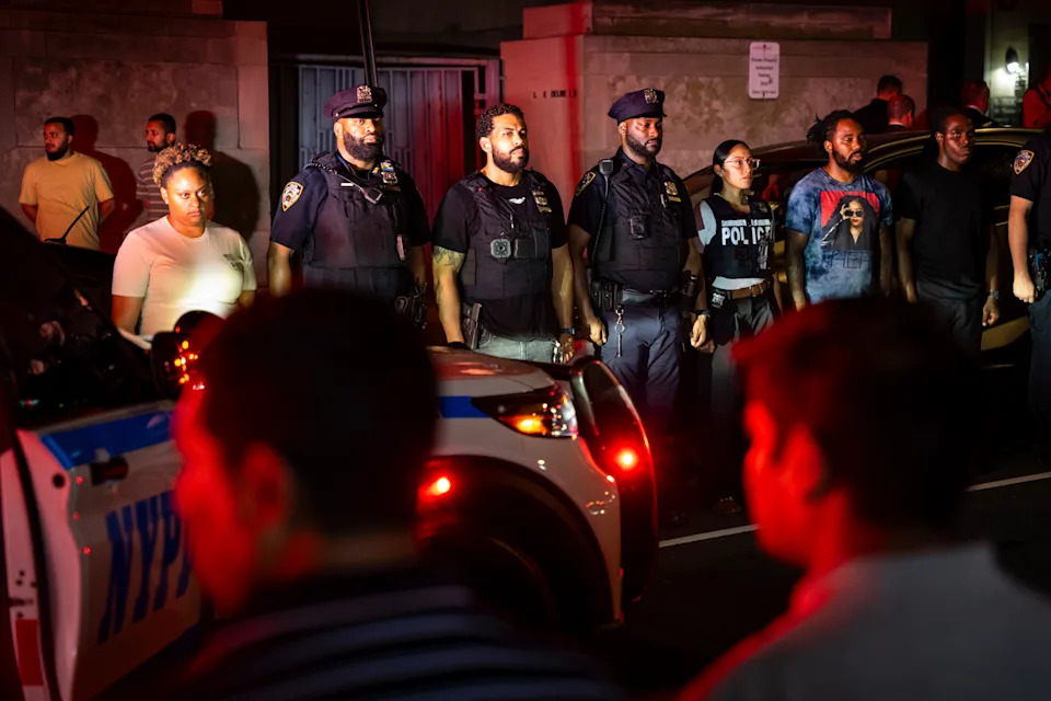 NYPD officers line up during the dignified transfer of Didarul Islam, who was shot and killed by a gunman earlier this evening, out of NewYork-Presbyterian/Weill Cornell Medical Hospital to the medical examiner's office, Tuesday, July 28, 2025, in New York. (AP Photo/Angelina Katsanis)