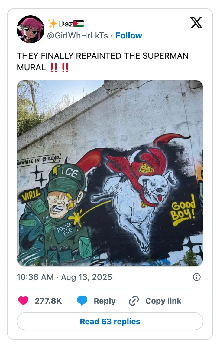 Mural of a dog in a Superman cape flying next to a cartoon officer labeled "ICE" tagged with "VIRAL" and "GOOD BOY!"