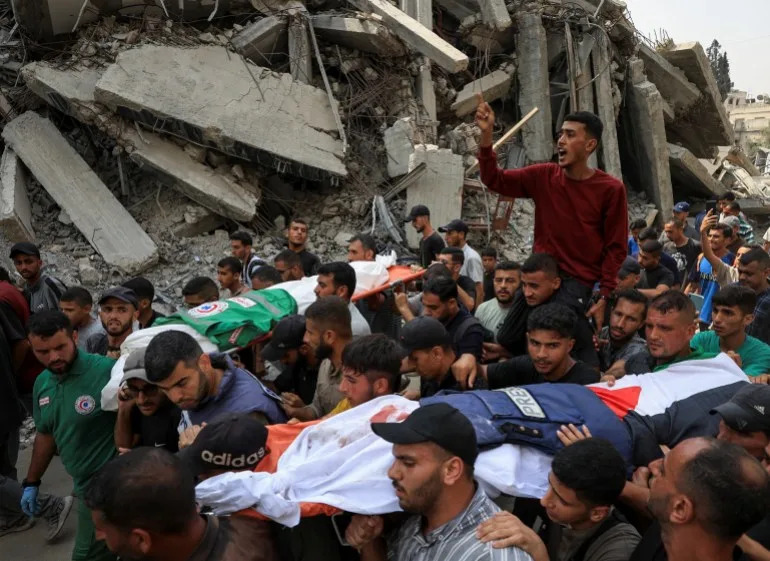 A flak jacket and a Palestinian flag are placed on the body of Al Jazeera journalist Anas Al Sharif, during the funeral for him, Mohammed Qreiqeh, Ibrahim Zaher, Mohammed Noufal and another colleague, who were killed in an Israeli strike, in Gaza City August 11, 2025. [Dawoud Abu Alkas/Reuters]