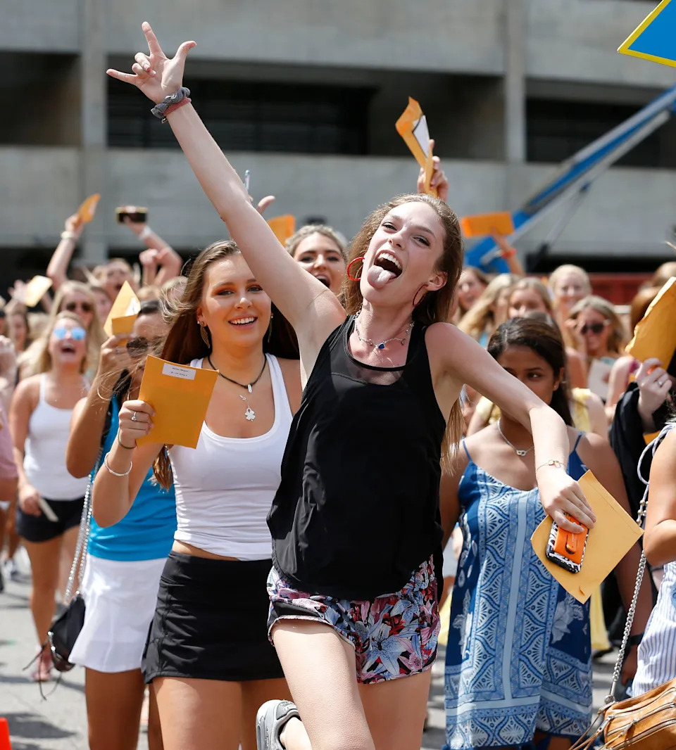 New sorority sisters join their sororities on Bid Day Sunday, August 19, 2018 on Sorority Row outside Bryant-Denny Stadium. A new member of Delta Delta Delta shows her enthusiasm as the new members parade to their house. [Staff Photo/Gary Cosby Jr.]