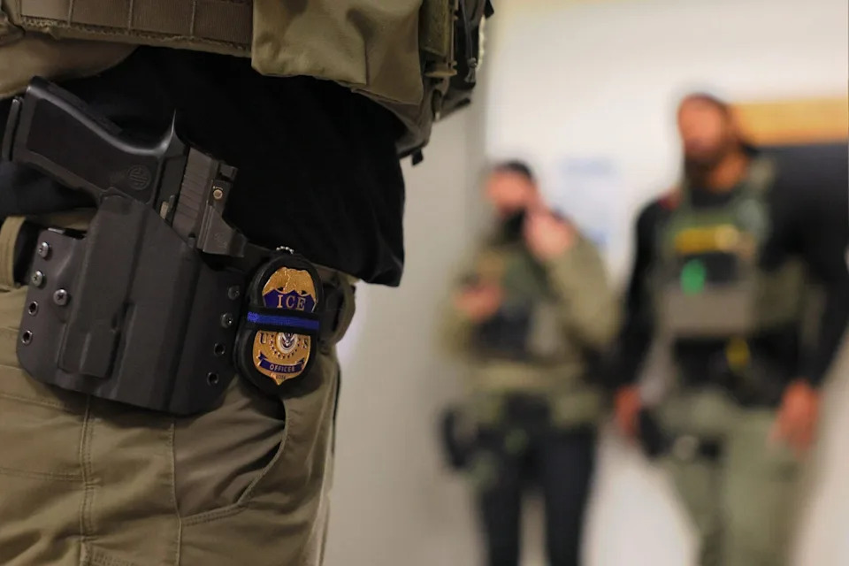 An ICE officer’s badge is seen as federal agents patrol the halls of immigration court at the Jacob K. Javitz Federal Building on June 10, 2025 in New York City. The Trump administration has ordered officials to increase detentions to 3,000 per day.