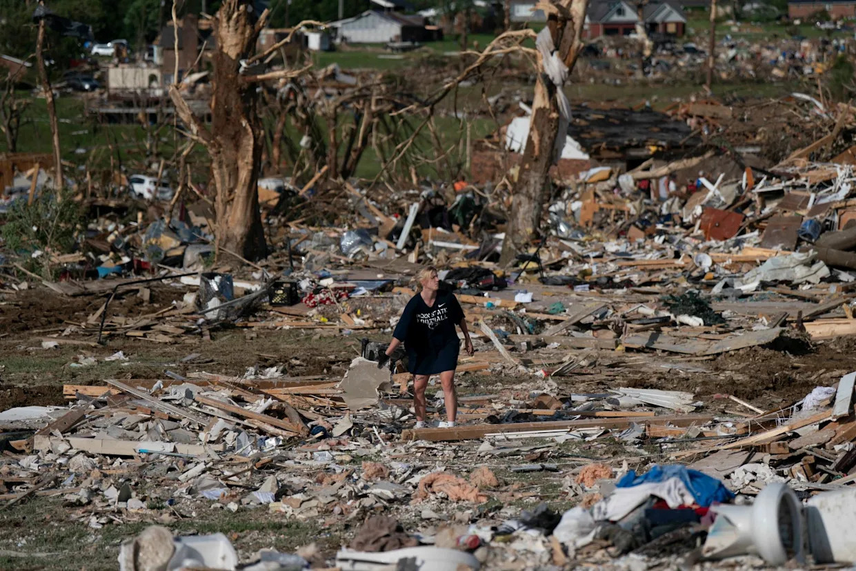 <span>A volunteer sorts through the debris of a home after a tornado hit areas of London, Kentucky, on 18 May 2025.</span><span>Photograph: Allison Joyce/EPA</span>