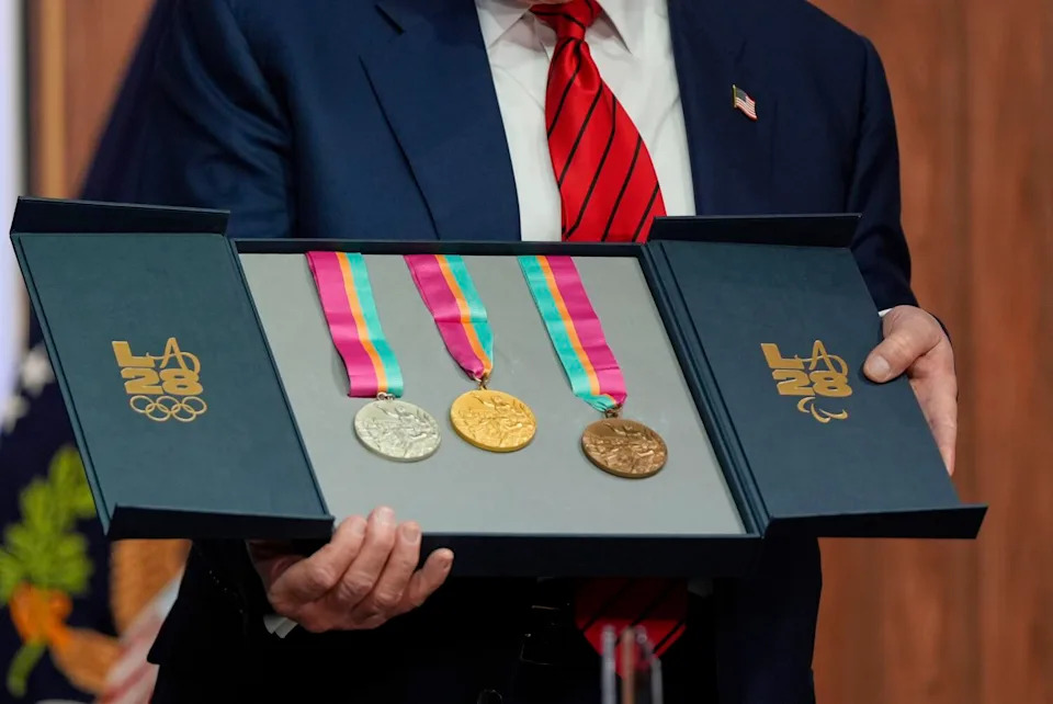 President Trump holds a full set of medals from the 1984 Olympics in Los Angeles.
