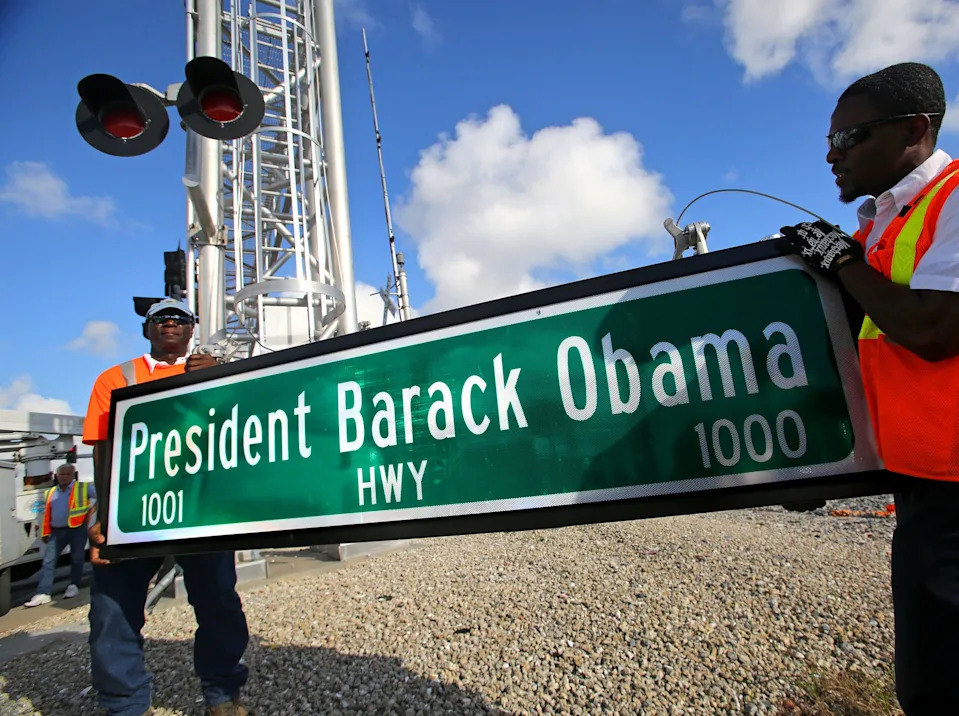 Palm Beach County Traffic Operations prepare to change a street sign for Old Dixie Highway in Riviera Beach to the new President Barack Obama Highway on Dec. 17, 2015.
