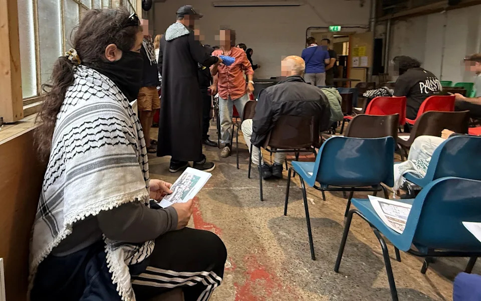 People attend a meeting on July 24 to organise a mass protest in support of the proscribed terror group Palestine Action