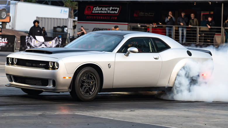 A silver Dodge Challenger SRT Demon 170 burning rubber