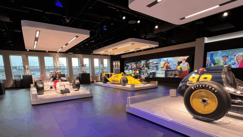 Inside the Penske Gallery with some of Team Penske's legendary race cars—where I could see the visible evolution of safety technology across decades of racing that directly influenced the protection systems in today