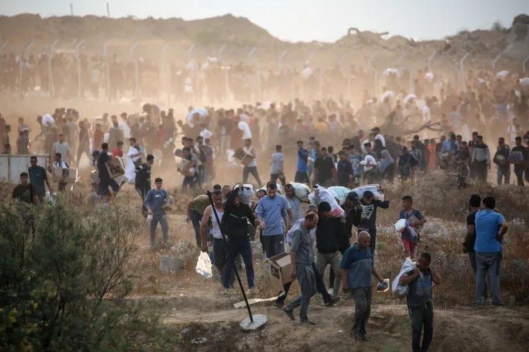People carry aid in Gaza