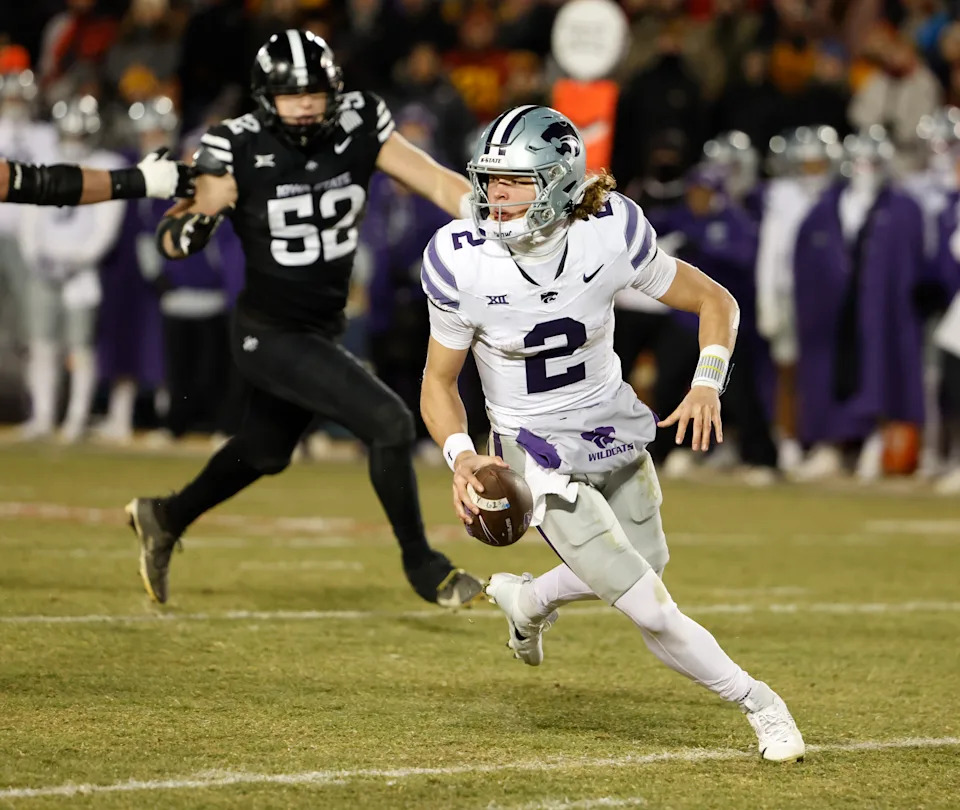 AMES, IA - NOVEMBER 30: Quarterback Avery Johnson #2 of the Kansas State Wildcats scrambles under pressure from defensive end Joey Petersen #52 of the Iowa State Cyclones in the second half of play at Jack Trice Stadium on November 30, 2024, in Ames, Iowa. The Iowa State Cyclones won 29-21 over the Kansas State Wildcats. (Photo by David K Purdy/Getty Images)