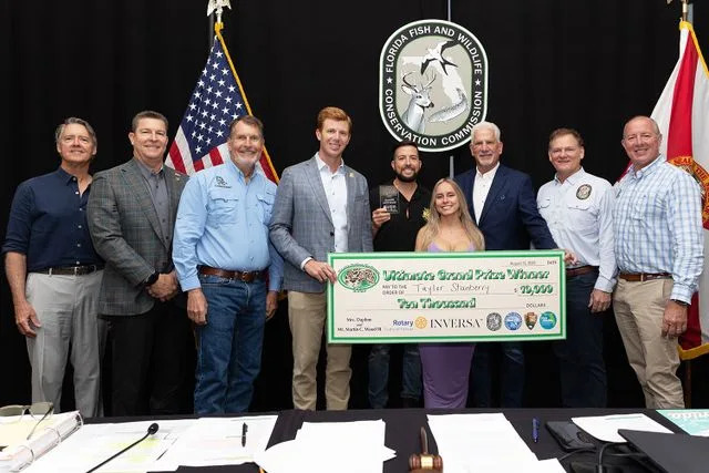 Florida Fish and Wildlife Conservation Commission Taylor Stanberry, winner of the FWC's 2025 Florida Python Challenge grand prize, poses with a check