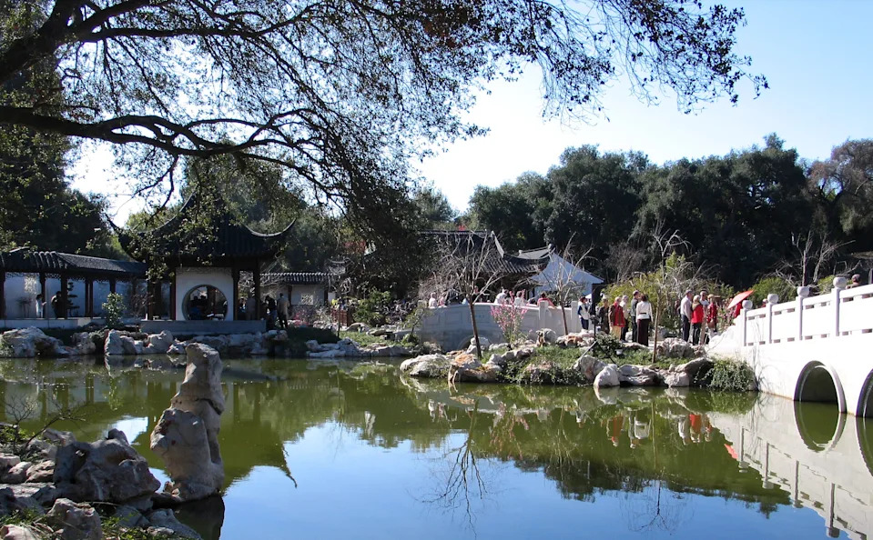 In this 2008 file photo, visitors walk over the Jade River Bridge (L) facing the Pavilion of the Three Friends in Liu Fang Yuan, or the Garden of Flowing Fragrance, at the Huntington Library Art Collections and Botanical Gardens in San Marino.
