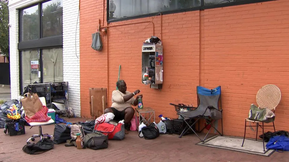Heather Bernard tidies up her encampment in the Mount Pleasant neighborhood before a potential clearing by local authorities on Wednesday. - Christine Lien/CNN