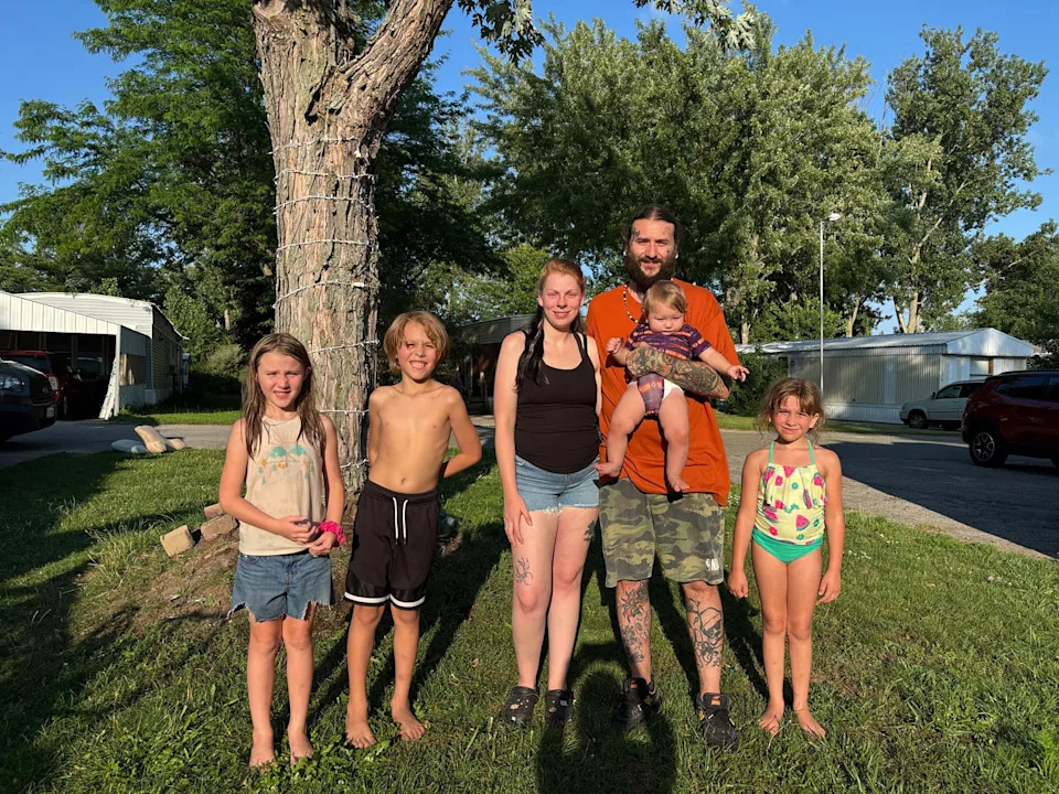 Image: Julia Ling and Michael Miller, center, were at a Walmart in Traverse City, Mich., with four of their children when a man allegedly stabbed 11 people on July 26, 2025. (Selina Guevara / NBC News)