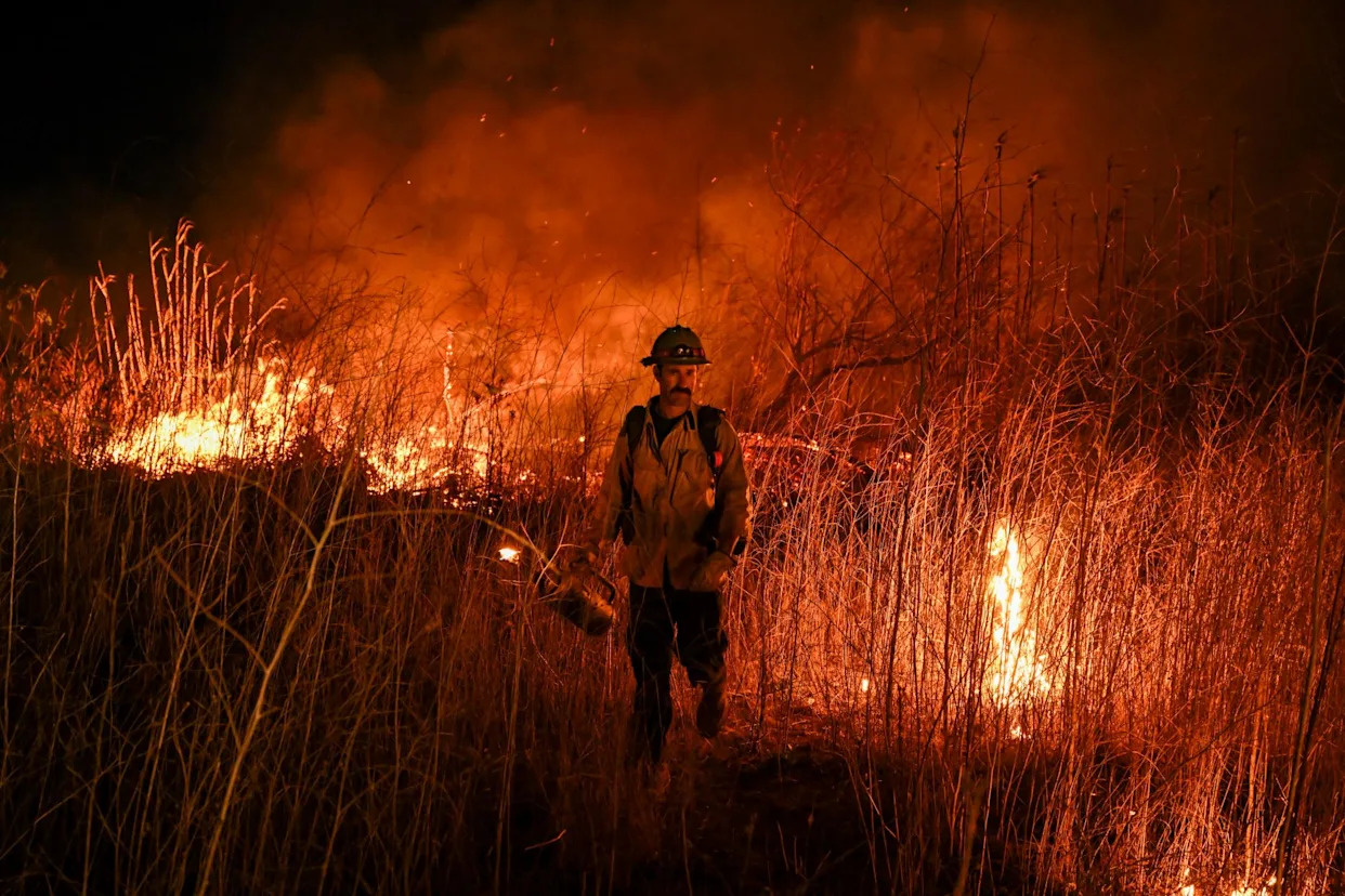 <span>A firefighter battles a brush fire in Ventura, California, on 13 January 2025.</span><span>Photograph: Anadolu/Getty Images</span>