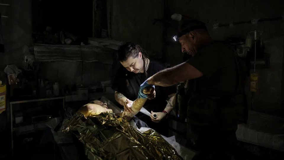 Combat medics of the Ukrainian Armed Forces treat an injured Ukrainian serviceman near Chasiv Yar on July 25. - Oleg Petrasiuk/Ukrainian Armed Forces/Reuters