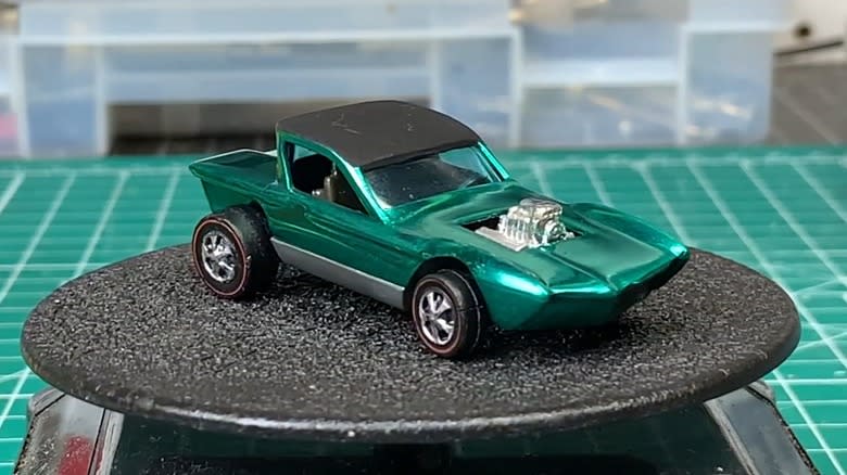 Three red 1968 Python Cheetah Hot Wheels cars with black roofs.