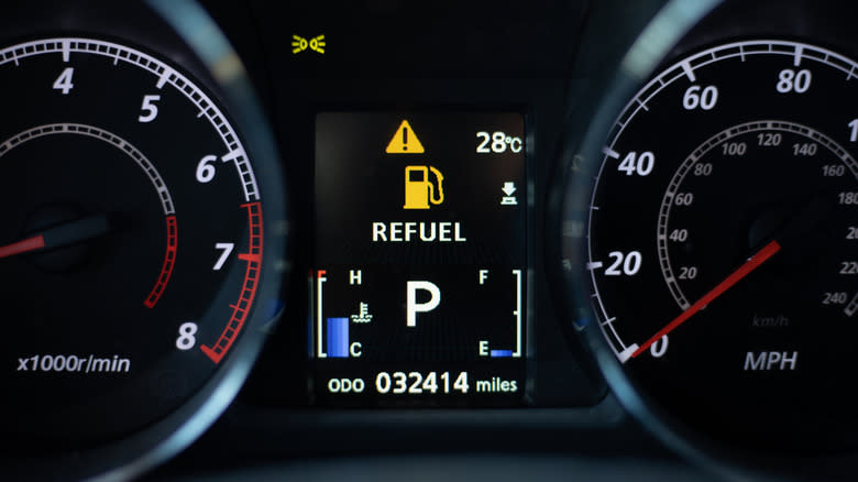 An automotive gauge cluster with the odometer in the middle.