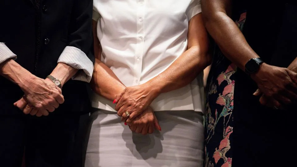 Chair of the Illinois Democratic Party Lisa Hernandez, center, stands alongside Texas state representatives during a news conference in Aurora, Illinois, on Tuesday. - Audrey Richardson/Bloomberg/Getty Images