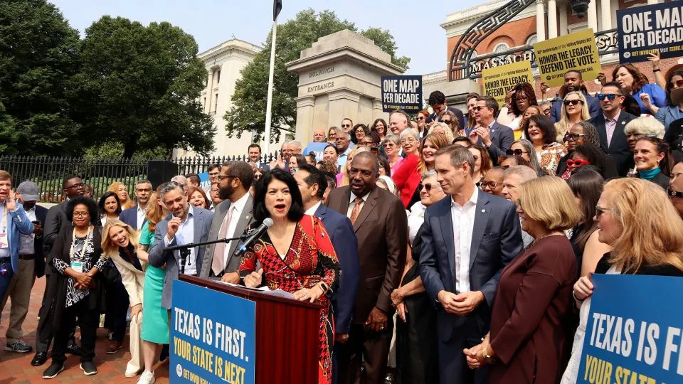 Texas State Sen. Carol Alvarado, a Democrat, speaks in a crowd of other Democratic state lawmakers outside the Massachusetts State House on August 6 in Boston. - Leah Willingham/AP