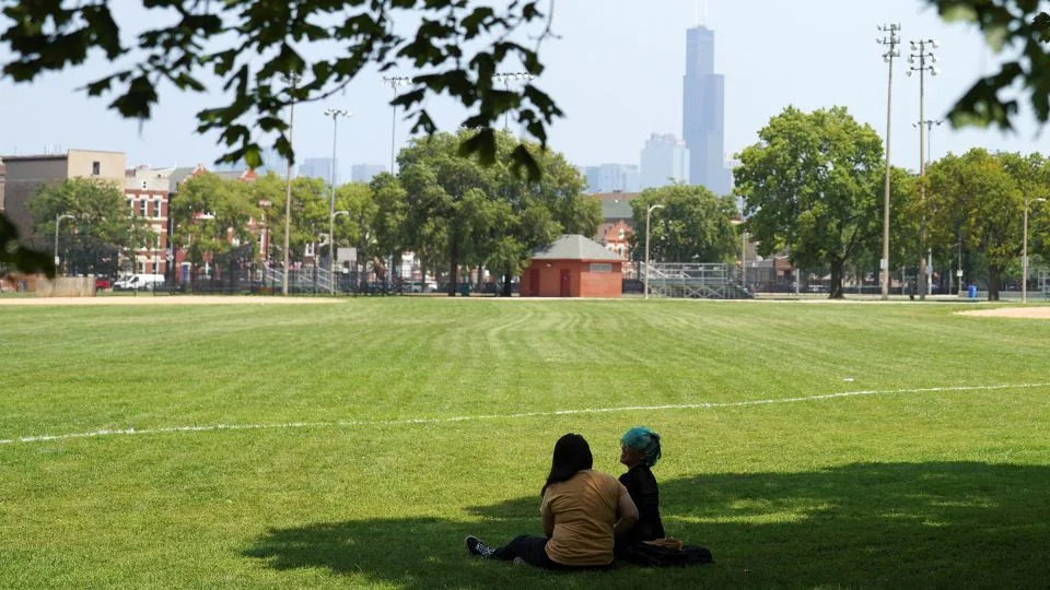 Jessica Gomez and Lesli Rodriguez rest in Harrison Park, in Chicago’s Pilsen neighborhood, as extreme heat and rising summer temperatures hit Chicago on July 23. - Audrey Richardson/Reuters