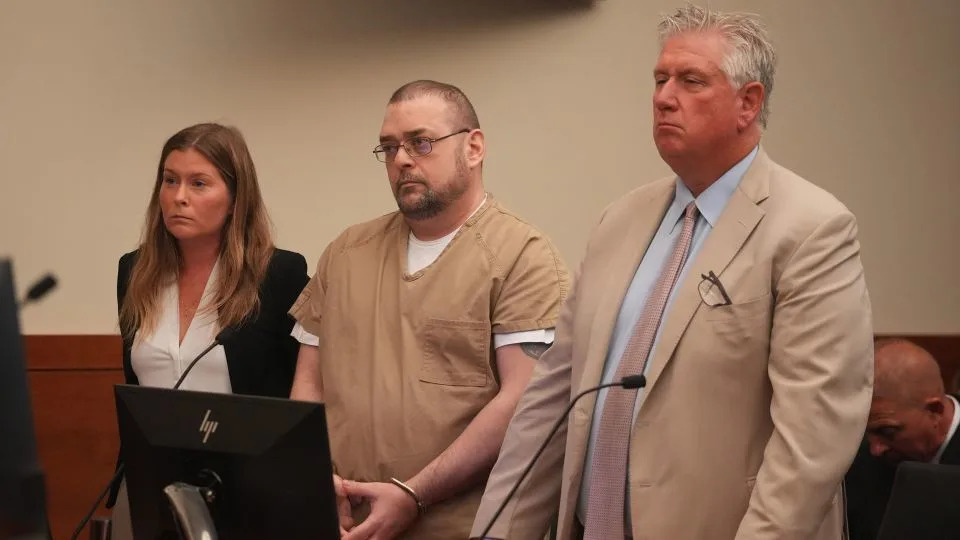 Former Columbus police officer Adam Coy (center) listens Monday to his sentence for the 2020 shooting death of Andre Hill. Defense attorneys Kaitlyn Stephens (left) and Mark Collins stand beside him. - Doral Chenoweth/Columbus Dispatch/USA Today Network/Imagn Images