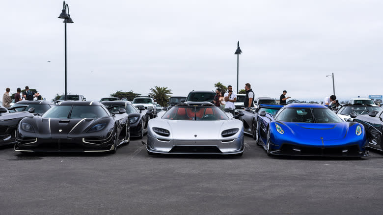 Three Koenigseggs lined up in a Car Week parking lot
