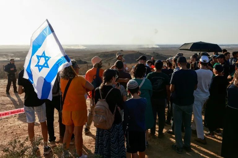 Israeli settlement activists gather on a hill overlooking war-devastated Gaza to stake their claim to the battered territory. (Menahem KAHANA)