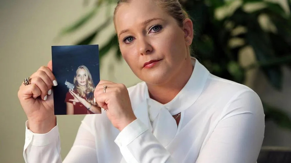 Virginia Giuffre, with a photo of herself as a teen, when she said she was abused by Jeffrey Epstein, Ghislaine Maxwell and Prince Andrew, among others. - Miami Herald/Tribune News Service/Getty Images