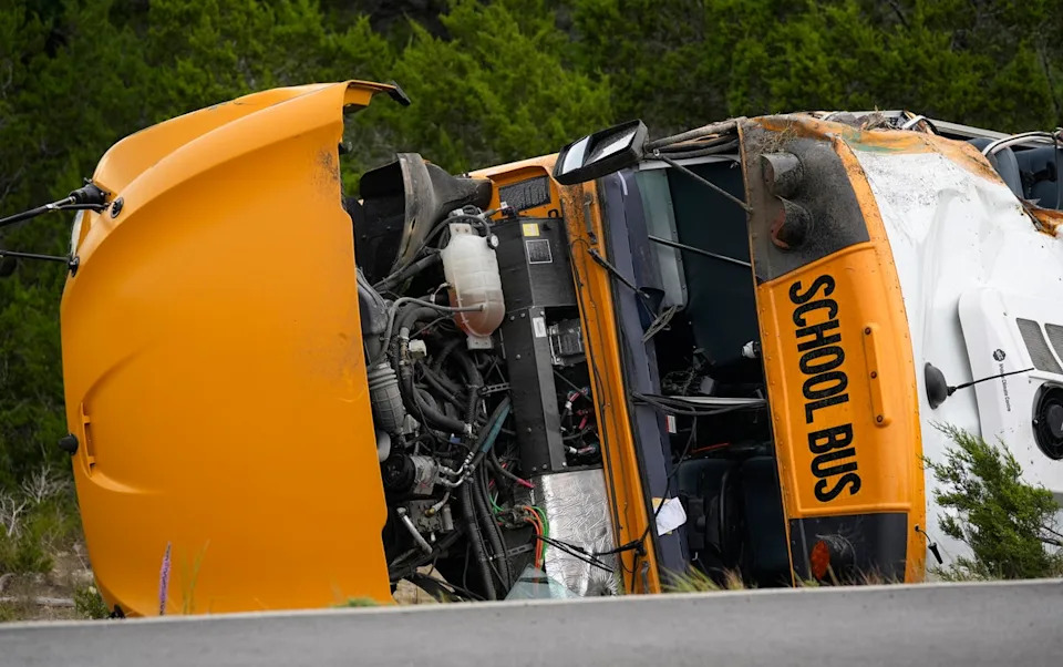 A Leander Independent School District bus lies on its side after crashing in Texas on Wednesday (AP)