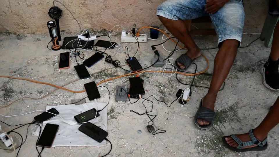 People charge cell phones during a nationwide blackout in Havana in March. - Yamil Lage/AFP via Getty Images