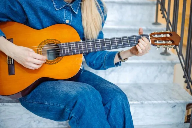Getty Stock photo of a woman playing her guitar