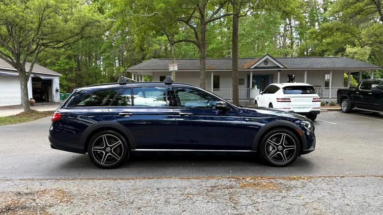 a side view of a Mercedes-Benz E-Class All-Terrain parked on a neighborhood street