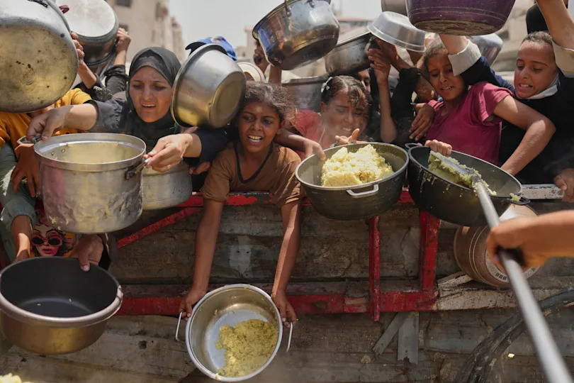 Palestinians struggle to get donated food at a community kitchen in Gaza City, northern Gaza Strip, Saturday, Aug. 16, 2025. / Credit: Jehad Alshrafi / AP