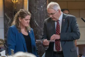 State Sen. Rob Clements of Elmwood, right, talks with State Sen. Carolyn Bosn of Lincoln on the floor of the Nebraska Legislature. Feb. 27, 2024. (Zach Wendling/Nebraska Examiner)