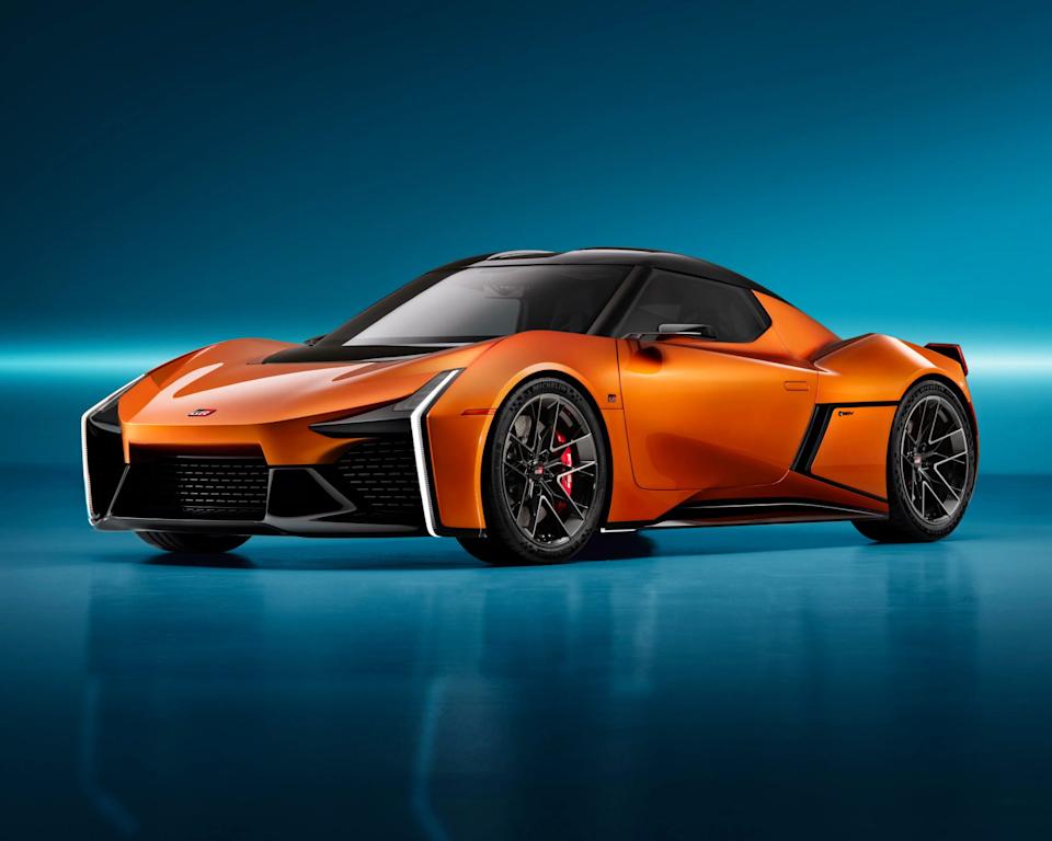 a photo of an orange toyota concept car in a studio