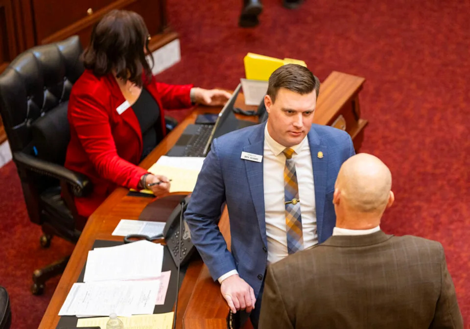 Sen. Ben Adams, R-Nampa, (center) chats with a colleague on the Senate floor on the morning of March 10, 2025, at the Idaho Capitol Building in Boise. (Pat Sutphin for the Idaho Capital Sun)
