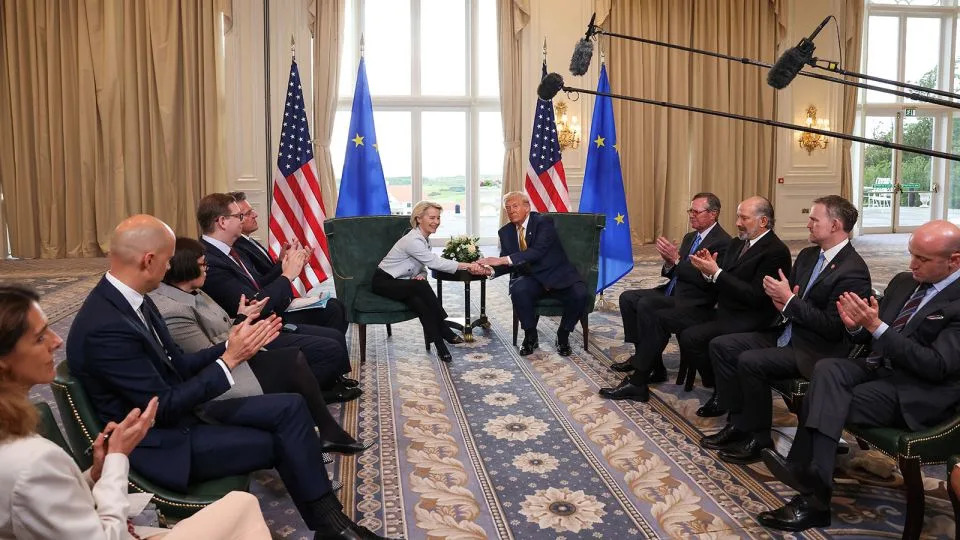 President Donald Trump shakes hands with European Commission President Ursula von der Leyen, as US Commerce Secretary Howard Lutnick, US Trade Representative Jamieson Greer and White House Deputy Chief of Staff Stephen Miller clap after an announcement of a trade deal between the US and EU in Turnberry, Scotland, on July 27. - Evelyn Hockstein/Reuters