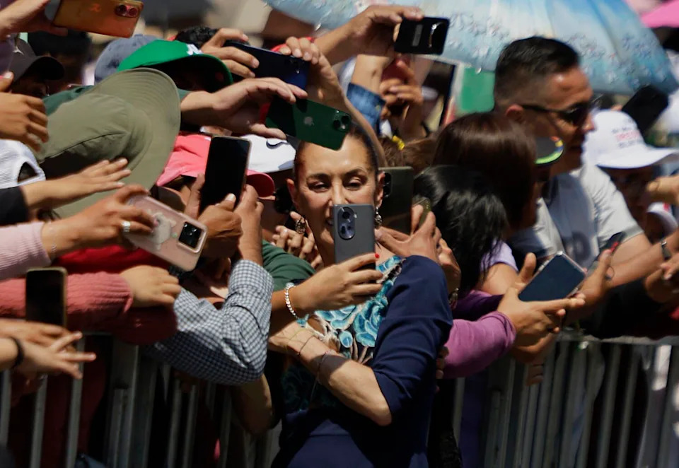 Claudia Sheinbaum, president of Mexico, greets her followers during a message she gives at the Zocalo in Mexico City