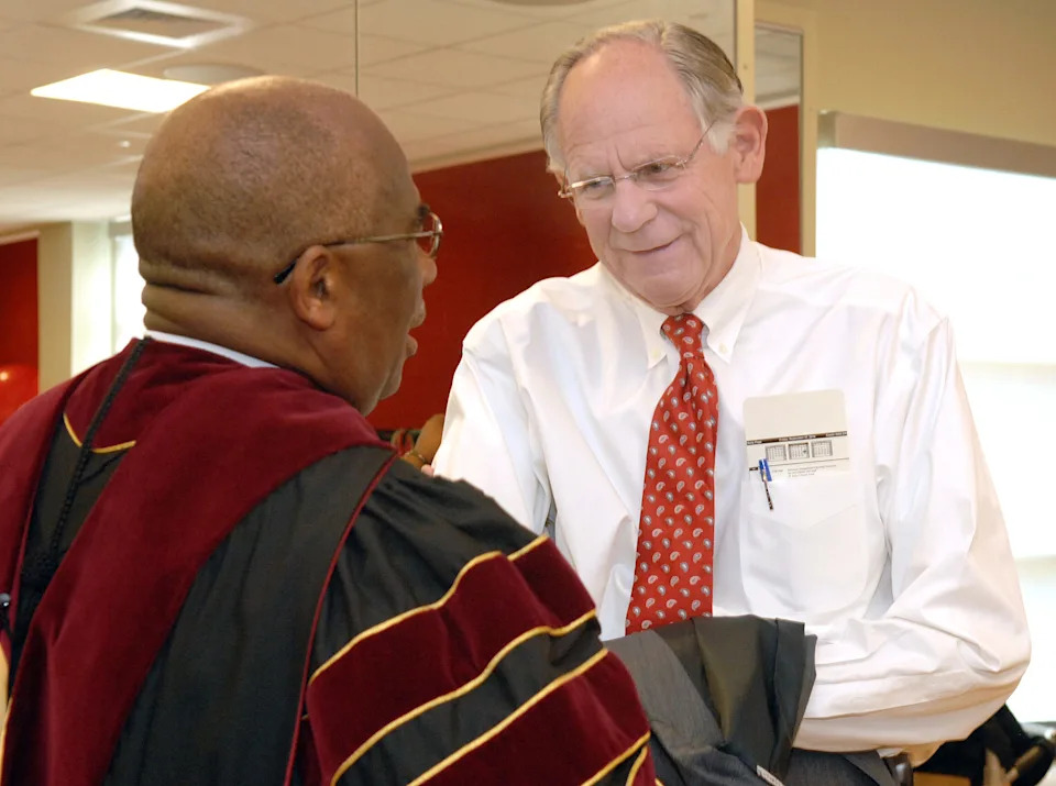 Congressman Mike Castle talks with Hazell Reed from Central North Carolina University during the installation ceremony of Delaware State University's 10th president, Harry L. Williams on Sept. 17, 2010.