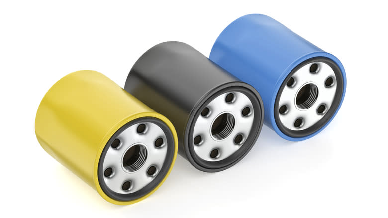 A display of three colorful spin-on oil filters