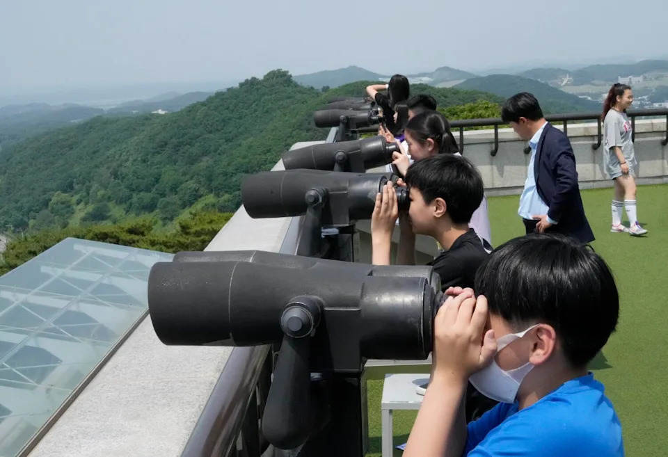 Elementary school students watch the North Korea side from taju, South Korea, near the border