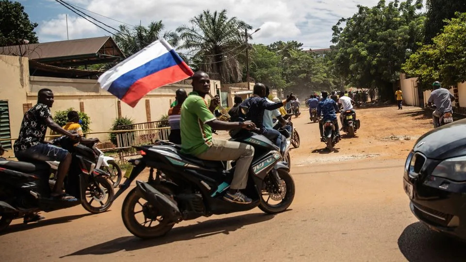 Supporters of junta leader Capt. Ibrahim Traore wave a Russian flag in the streets of Ouagadougou, Burkina Faso, on Oct. 2, 2022. - Sophie Garcia/AP