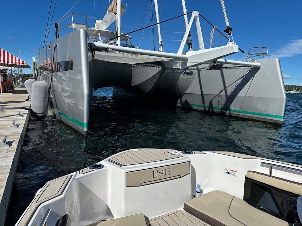 yamaha 255 fsh docked in front of a catamaran.