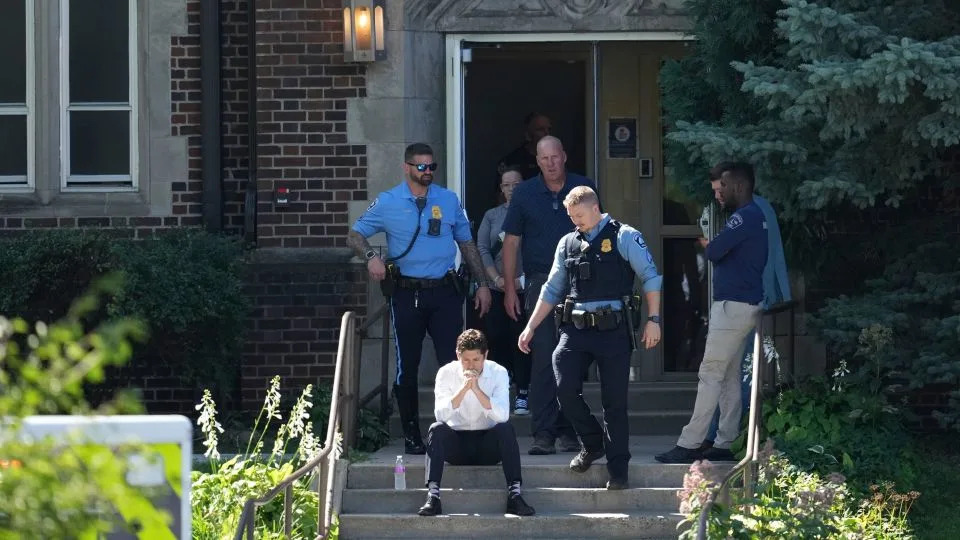 Minneapolis Mayor Jacob Frey sits on the steps of the Annunciation Church's school after the shooting Wednesday morning. - Abbie Parr/AP