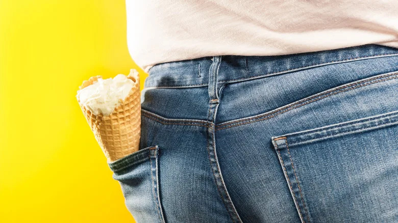 Person with an ice cream cone in the back pocket of their jeans