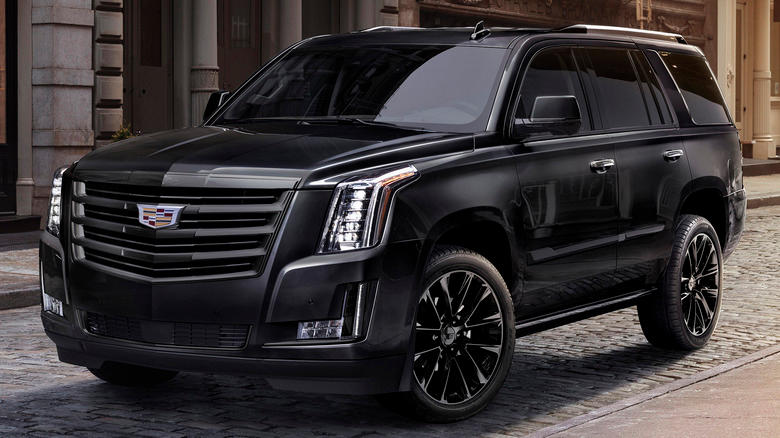 A black 2020 Cadillac Escalade with storefronts in the background