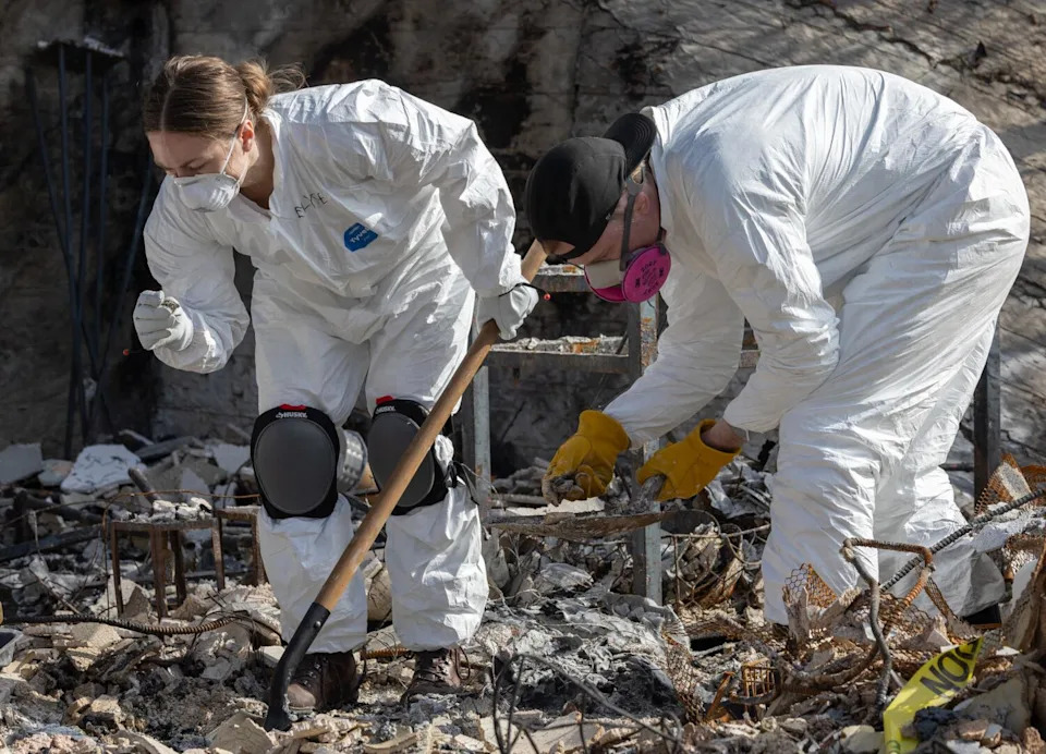 Elyse Mallonee, left, and Parker Sheriff carefully sift through rubble and ash in Altadena on Feb. 18.