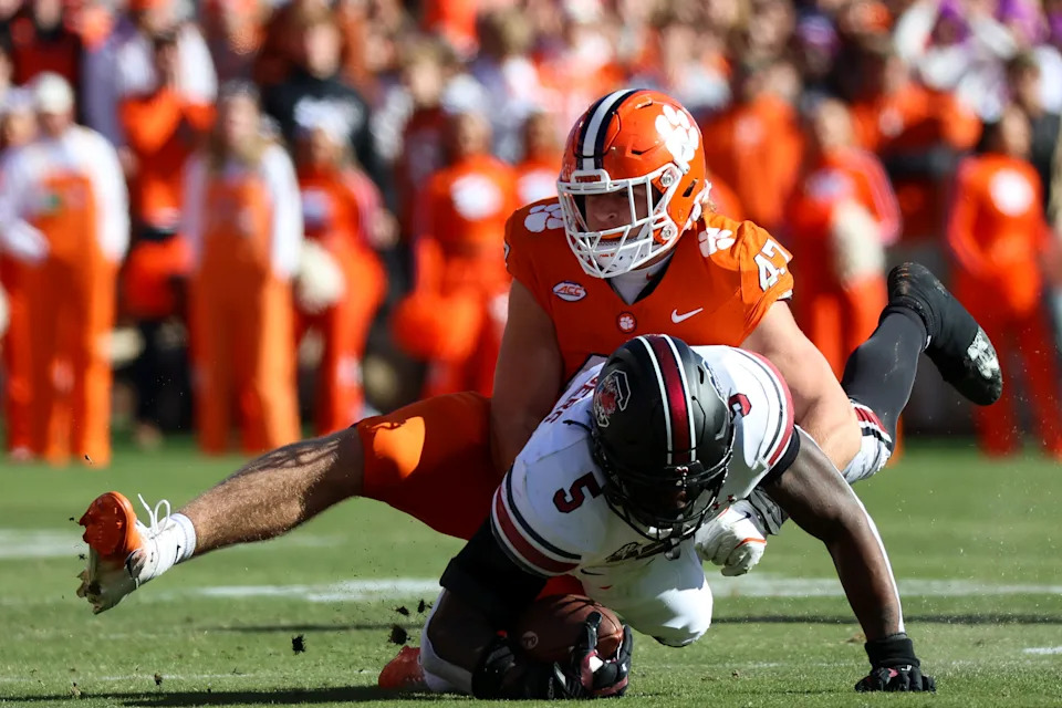 CLEMSON, SOUTH CAROLINA - NOVEMBER 30: Sammy Brown #47 of the Clemson Tigers tackles Raheim Sanders #5 of the South Carolina Gamecocks at Memorial Stadium on November 30, 2024 in Clemson, South Carolina.  (Photo by Isaiah Vazquez/Getty Images)