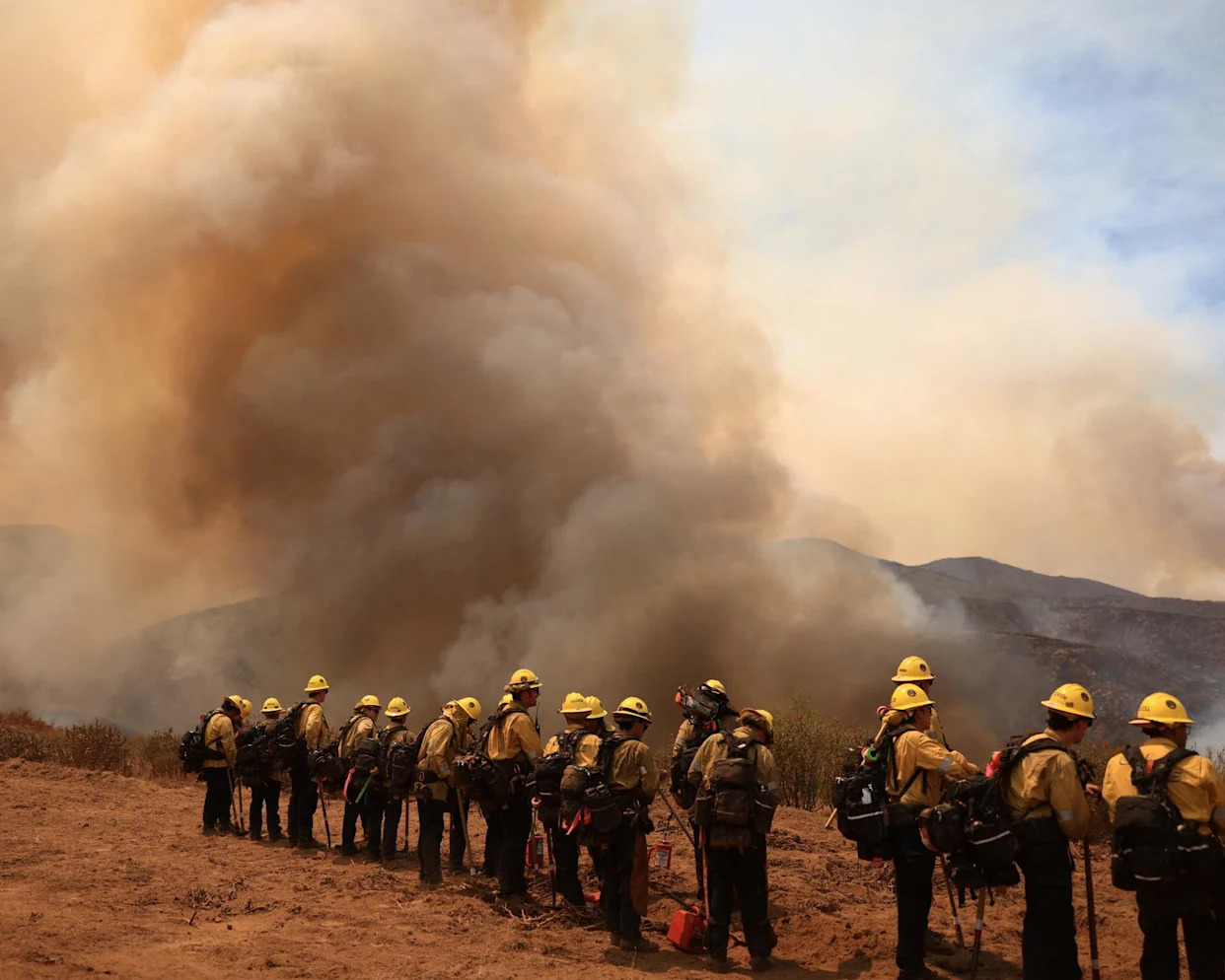 <span>Firefighters battle the Gifford fire in brush-covered hillsides west of New Cuyama, California, on Monday.</span><span>Photograph: David Swanson/Reuters</span>